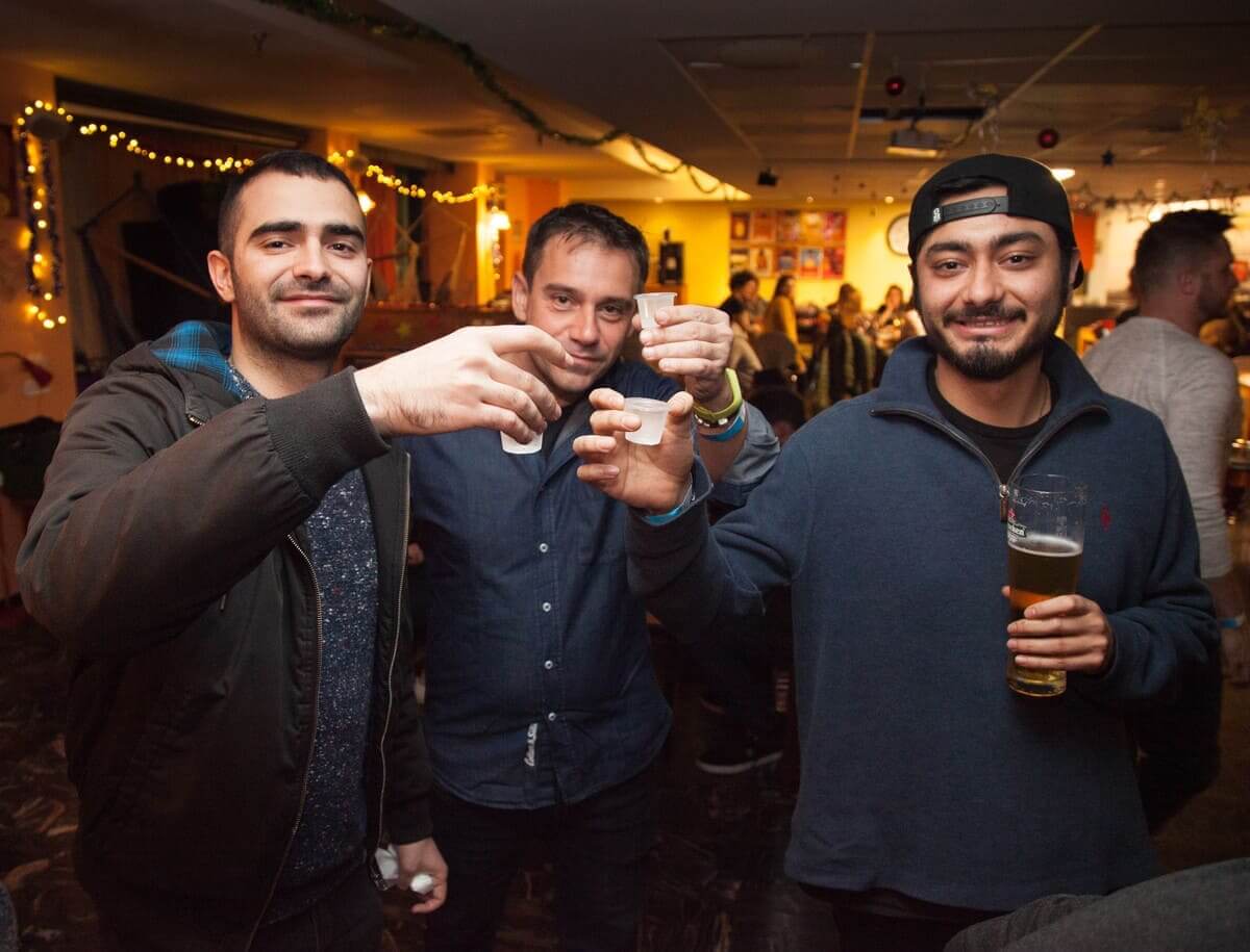 3 guys drinking alcohol on Jerusalem Pub Crawl