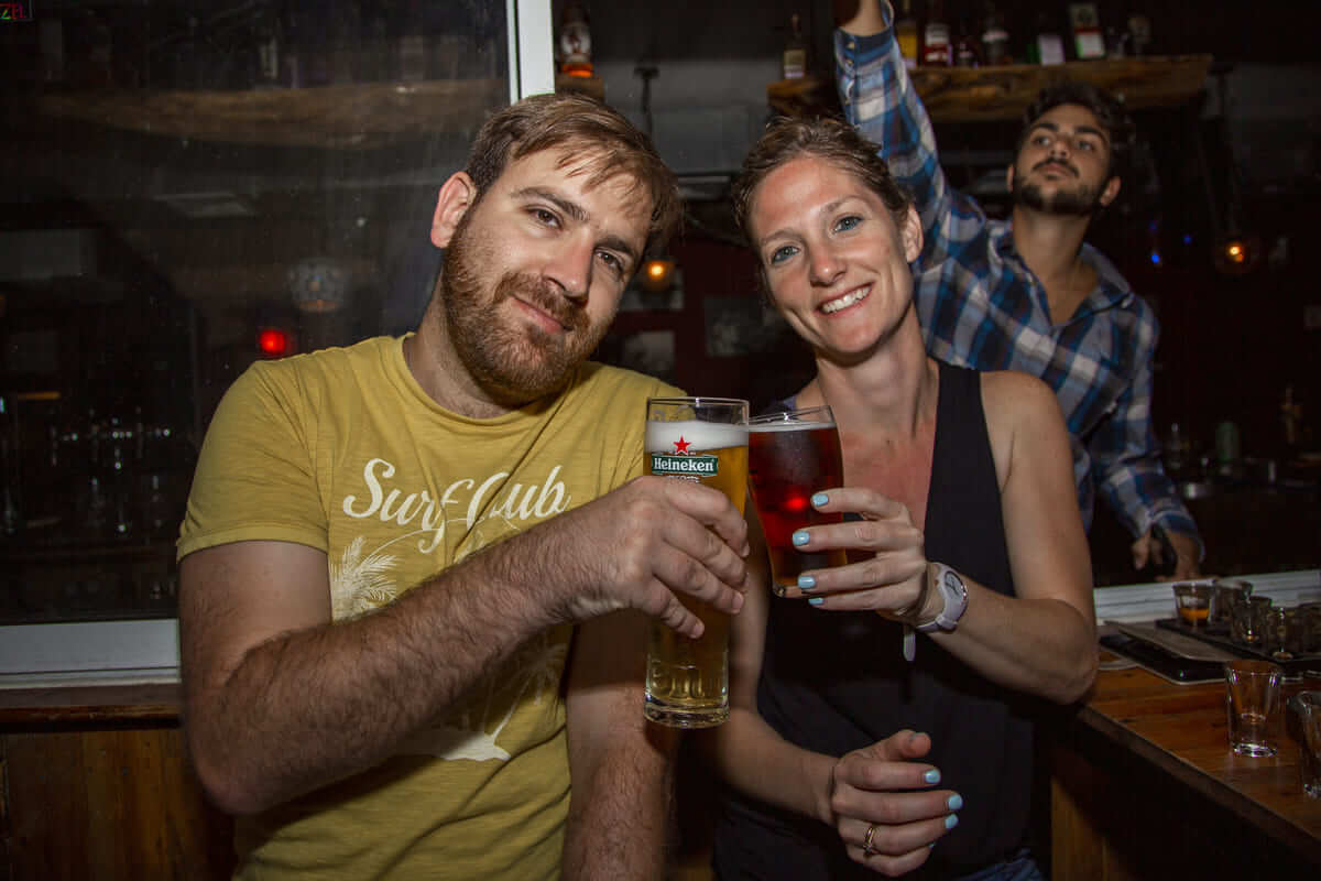 Two people with beer at the bar